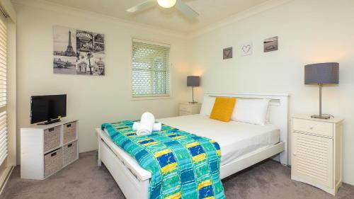 a bedroom with a bed and a tv in it at Jubilee Views Holiday Apartments in Gold Coast