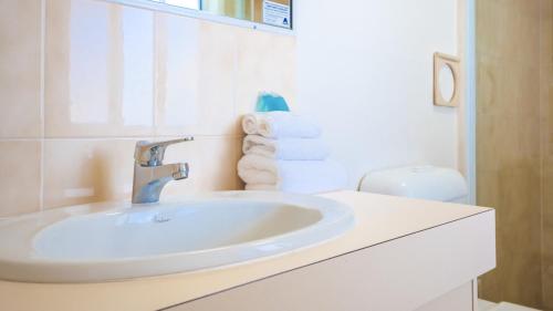 a white bathroom with a sink and a toilet at Jubilee Views Holiday Apartments in Gold Coast