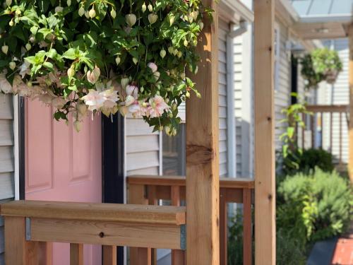 a porch with a potted plant on a wooden railing at Inn at the Prom Oceanfront in Seaside