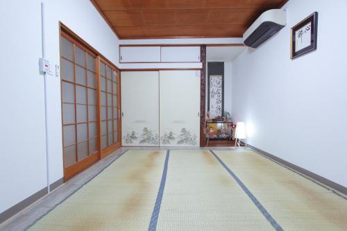 an empty room with a large window at I Osaka Traditional in Osaka