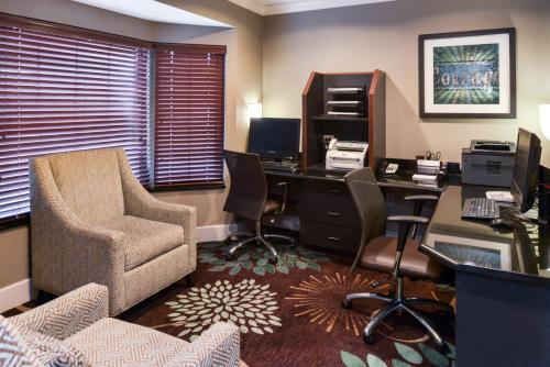 an office with a desk with a computer and a chair at Staybridge Suites Indianapolis Downtown-Convention Center by IHG in Indianapolis