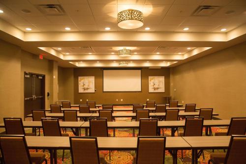 a conference room with tables and chairs and a whiteboard at Holiday Inn Murfreesboro by IHG in Murfreesboro