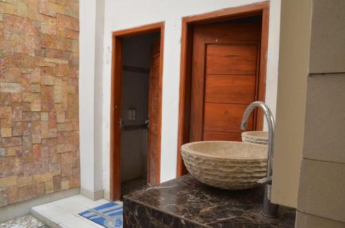 a bathroom with a large stone sink on a counter at ChiGhaya Guest House in Lawean