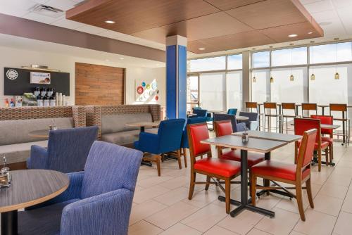 a restaurant with tables and chairs and a bar at Holiday Inn Express & Suites - Van Horn, an IHG Hotel in Van Horn