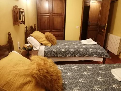 a bedroom with two beds and a teddy bear on the bed at Cal Pons in Prades
