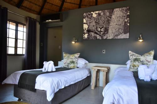 a bedroom with two beds with towels on them at Bayala Private Safari Lodges in Hluhluwe