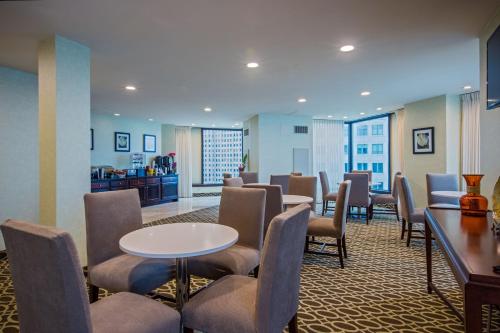 a waiting room with a table and chairs at Fort Pontchartrain Detroit, a Wyndham Hotel in Detroit