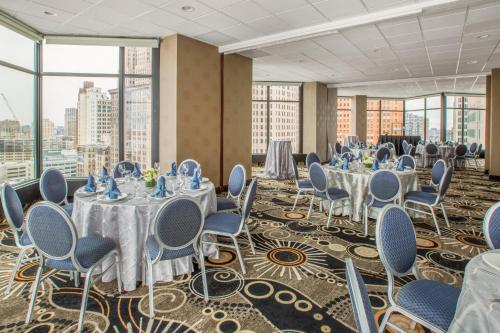 a conference room with tables and chairs and windows at Fort Pontchartrain Detroit, a Wyndham Hotel in Detroit