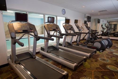 a row of treadmills in a gym with exercise bikes at Holiday Inn Morgantown-University Area by IHG in Morgantown