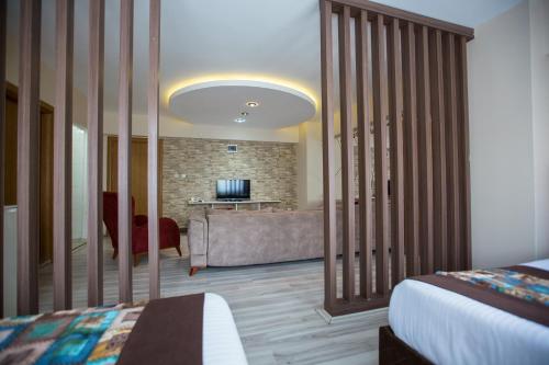a hotel room with a bed and a couch at Formback Thermal Suit & Apart in Bursa