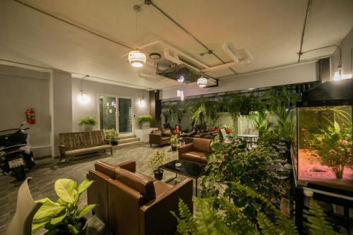 a living room filled with lots of furniture at Nalanta Hotel Pattaya in Pattaya Central