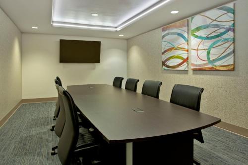 a conference room with a table and chairs at Holiday Inn Express Hotel & Suites Austin Downtown - University by IHG in Austin