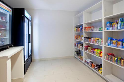 a grocery store aisle with shelves of food at Holiday Inn Express Hotel & Suites Austin Downtown - University by IHG in Austin