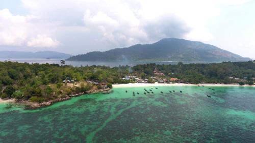 an island in the ocean with people in the water at Chareena Garden in Ko Lipe