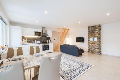 a kitchen and living room with a table and chairs at Čajkovskij Apartments in Brno