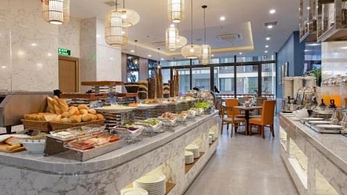 a buffet line in a restaurant with a lot of food at Seana Hotel in Nha Trang