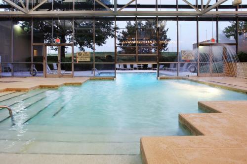 a swimming pool with blue water in a building at Holiday Inn Knoxville West - Cedar Bluff Rd by IHG in Knoxville
