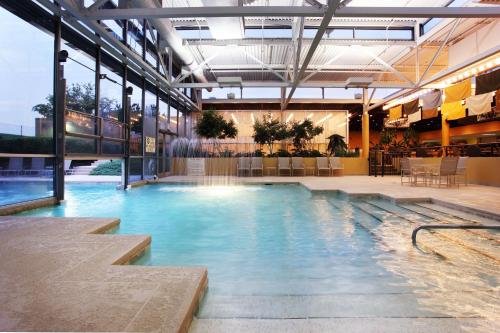 a large indoor swimming pool in a building at Holiday Inn Knoxville West - Cedar Bluff Rd by IHG in Knoxville