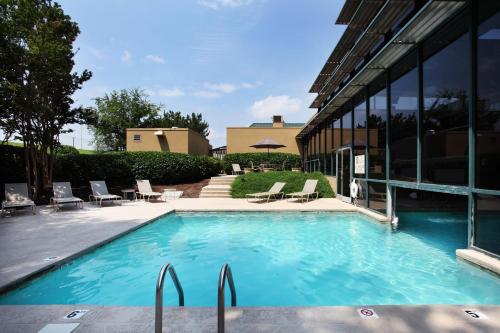 a swimming pool in front of a building at Holiday Inn Knoxville West - Cedar Bluff Rd by IHG in Knoxville