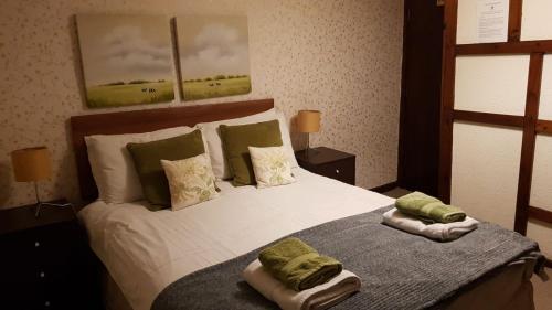 a bedroom with a bed with two towels on it at The Wheatsheaf Inn in Ludlow