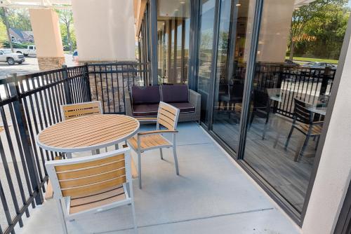a table and chairs sitting on a balcony at Holiday Inn Knoxville N - Merchant Drive by IHG in Knoxville
