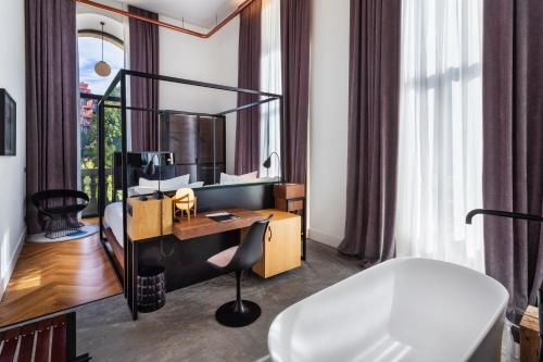 a hotel room with a desk and a mirror at One Shot Tabakalera House in San Sebastián