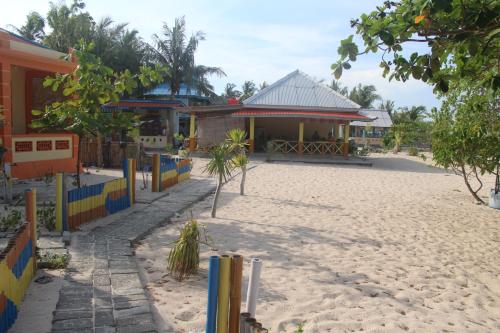 a building on the side of a beach with a fence at Ocean holiday in Bira