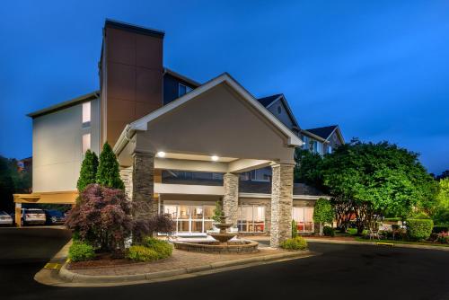 a large house with a building at Holiday Inn Express Chapel Hill by IHG in Chapel Hill