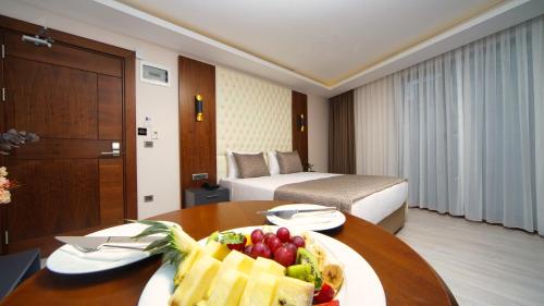 a hotel room with a table with a plate of fruit at My Dream Istanbul Hotel in Istanbul