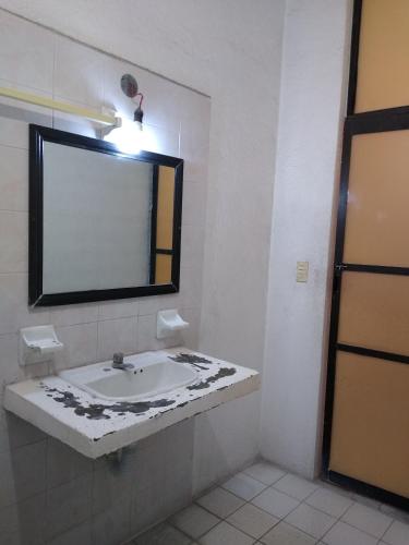 a bathroom with a sink and a mirror at Hotel Real Jojutla in Jojutla de Juárez