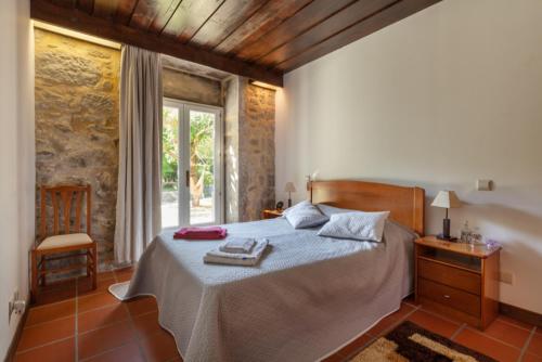 a bedroom with a bed in a room with a window at Quinta S. Romao do Neiva in Castelo do Neiva