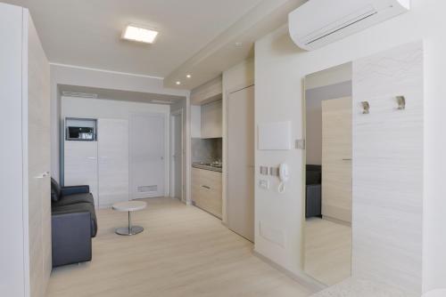 a kitchen with a white refrigerator and white cabinets at Residence Picalè in Alghero