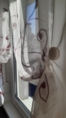 a close up of a window with curtains at Apartman Luna in Valjevo