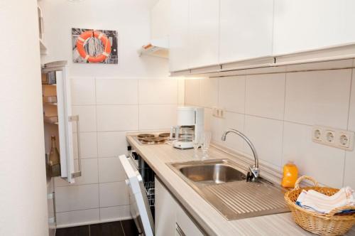 a kitchen with a sink and a counter top at Ferienwohnung in Damp Residenzblick an der Ostsee in Damp