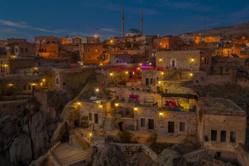 an overview of a city at night with lights at Kapadokya Ihlara Konakları Otel Konak Odaları in Guzelyurt