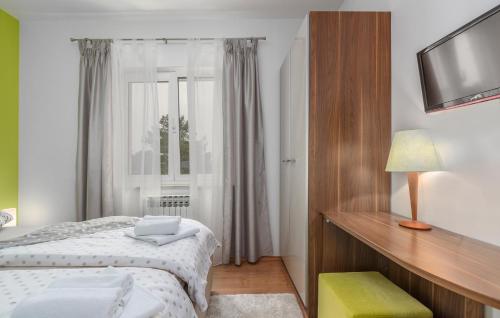 a small bedroom with a bed and a window at Luxury Villa Lavanda with Pool and Sauna in Kanfanar