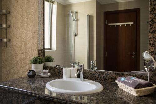 a bathroom counter with a sink and a shower at HiGuests - Unique Duplex Penthouse in JBR with Sea Views in Dubai