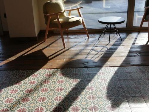 a shadow of a chair and a table on a floor at Arrels d'Emporda in Palafrugell