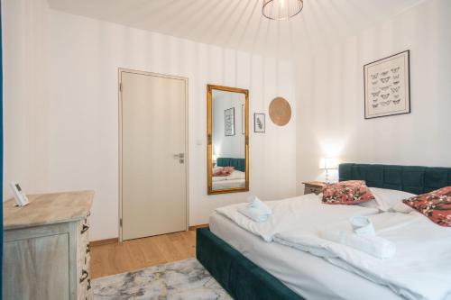 a bedroom with a large bed and a mirror at Apartment with Balcony in Prague