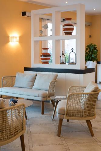 a living room with a couch and chairs at Lu' Hotel Riviera - Carloforte in Carloforte