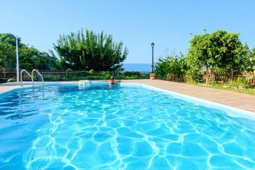 a swimming pool with a person in the water at Villa Evelina in Adelianos Kampos