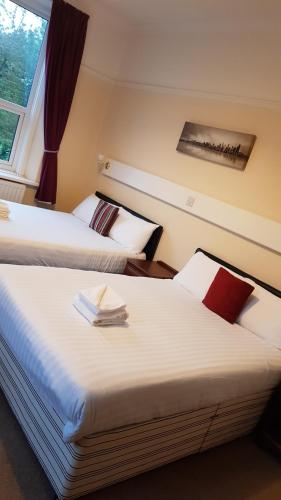 two beds sitting next to each other in a room at Croxdale Inn in Durham