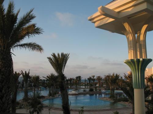 a view of a resort pool with palm trees at Hasdrubal Prestige Thalassa & Spa Djerba in Triffa