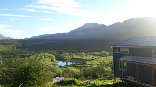 a house with a view of a river and mountains at Refugio del río, a orillas del río Cochrane in Cochrane