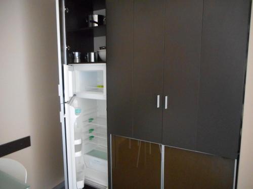 an open refrigerator with its door open in a room at Residence San Marino in San Marino