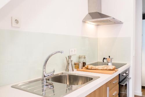 a kitchen with a sink and a counter top at Oceanográfico Apartments in Valencia
