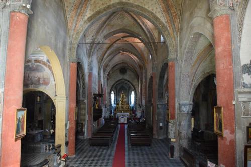 an aisle in a church with arched ceilings at Saluzzo Historic Center Apartment in Saluzzo