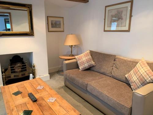 a living room with a couch and a table at Ye Olde House in Shepperton