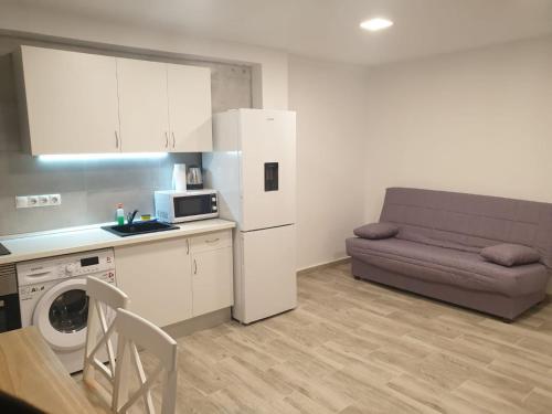 a kitchen and a living room with a couch at Style Apartments Cabanyal Marina Beach in Valencia