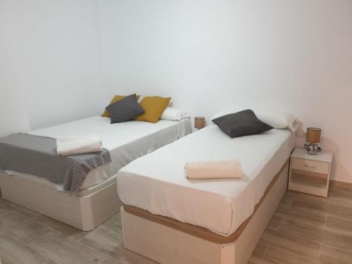 two beds sitting next to each other in a room at Style Apartments Cabanyal Marina Beach in Valencia